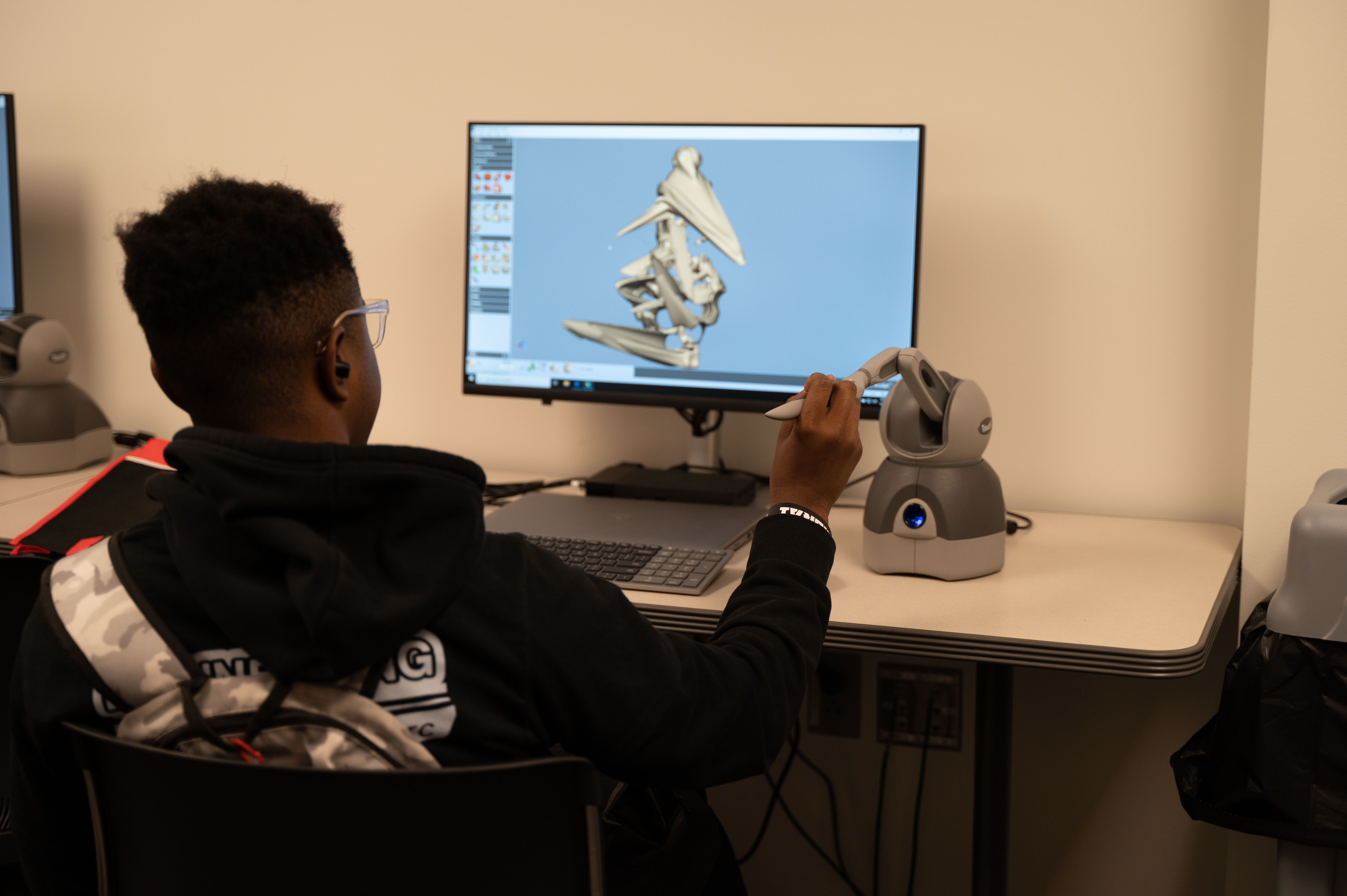 A student tries the haptic feedback pen at Manufacturing Day