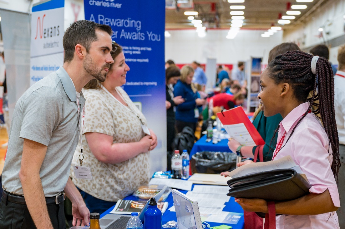 A student speaks with an employer rep at the Spring 2023 STEM Expo