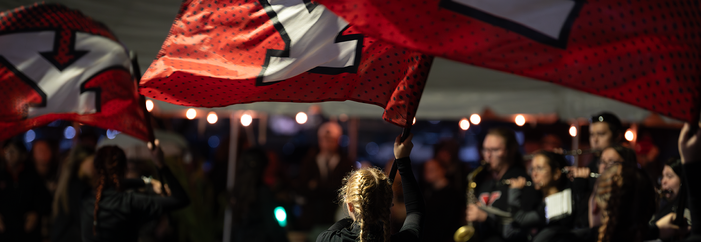 Color Guard with YSU flags at night