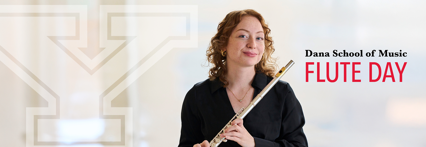 YSU Flute player smiling and posing with flute
