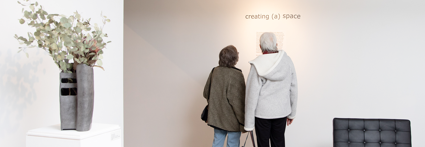 two museum attenders looking at exhibit