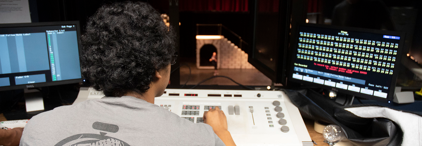 student managing stage equipment
