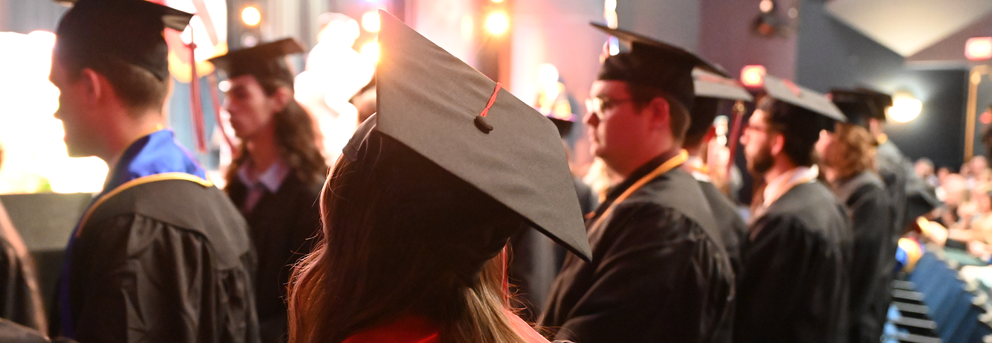 graduates with caps in Ford Theater, Bliss Hall