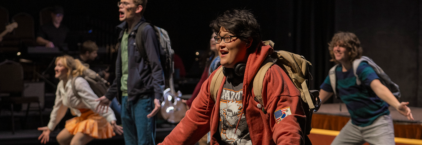 Student performers dancing and singing during production "Be More Chill"