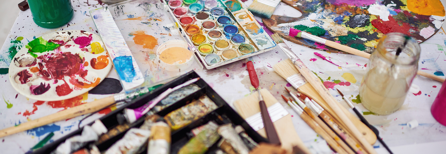 Close up of colorful, messy art supplies in use