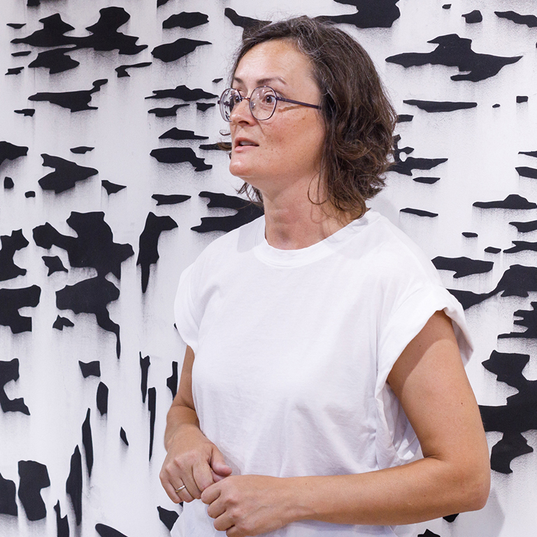 photo of Dragana Crnjak in front of her exhibition