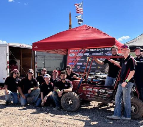YSU Penguin Baja Racing Team Members pose at the Arizona competition with this year's vehicle