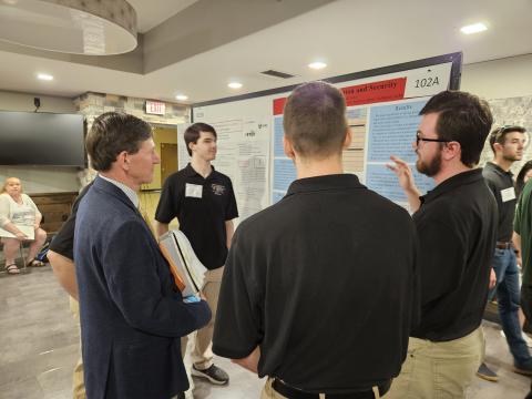COF Scholars present their research to John Magill