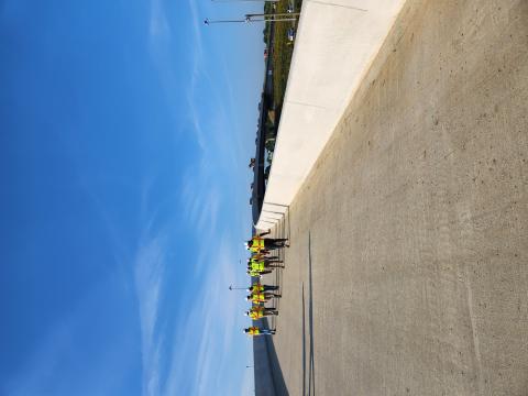 Students walk across a bridge at construction site